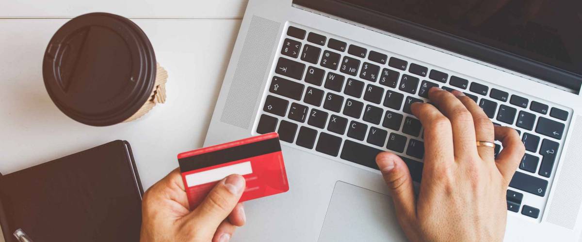 Top view of man using credit card for online shoping