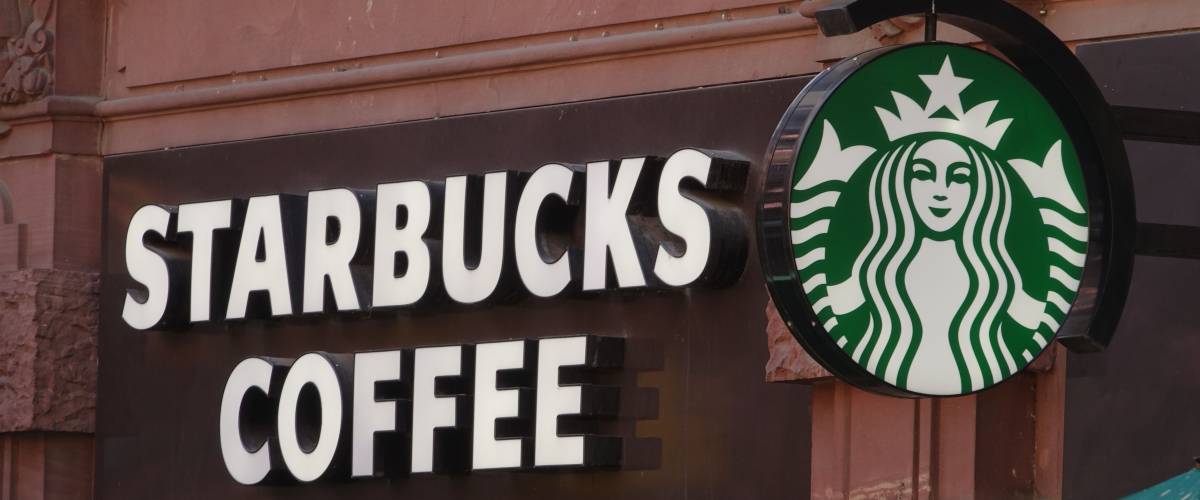 Outside view of Starbucks store with store sign and logo