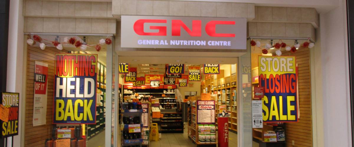 GNC store from outside, with signs signalling store closing