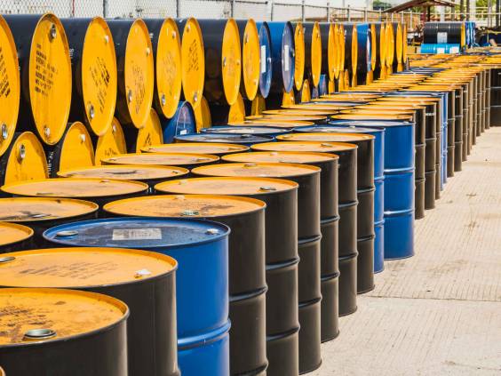 Industry oil barrels or chemical drums stacked up.container of barrels of hydrocarbons.hazardous waste of black and blue tank oil.Stack Of Oil barrels in plant.