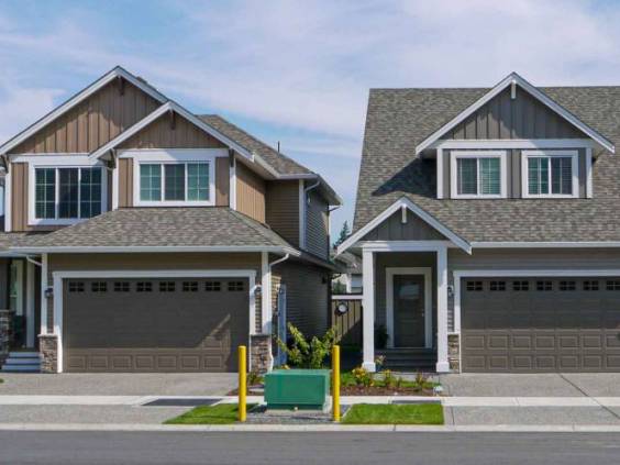 Brand new residential houses with concrete driveway and asphalt road in front