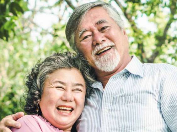 Happy elderly couple with lifestyle after retiree concept. Lovely asian seniors couple embracing together in the park in the morning.