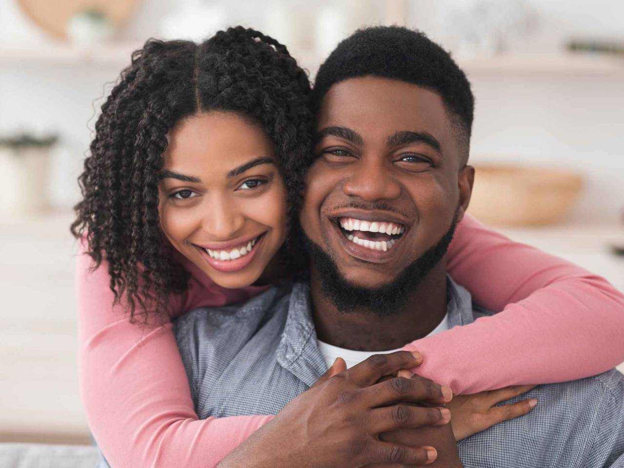 Portrait Of Loving African American Couple Hugging At Home And Looking At Camera, Spending Quarantine Together