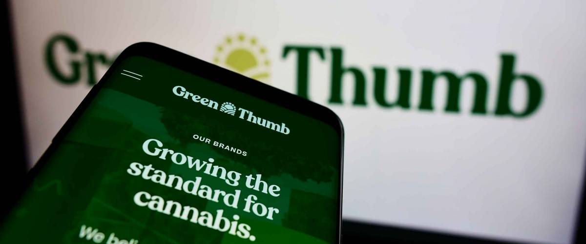 STUTTGART, GERMANY - Aug 14, 2021: Mobile phone with webpage of American cannabis company Green Thumb Industries Inc on screen in front of logo Focus on top-left of phone display