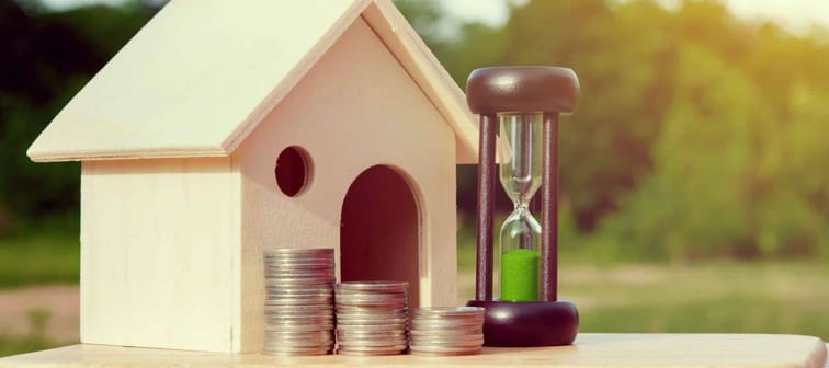 Loans to finance home building.Money Hourglass home.