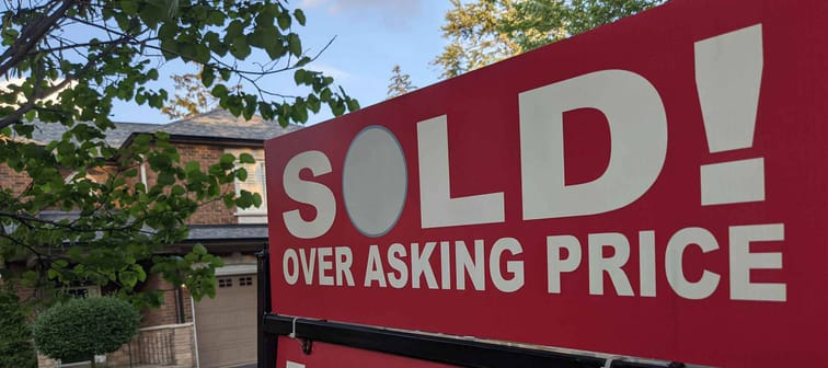 New sign sold over asking price for sale in front of detached house