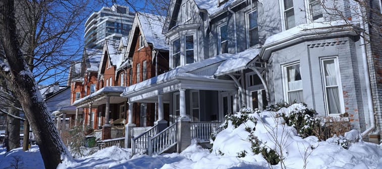 Winter scene with residential street with Victorian semi-detached houses with gables