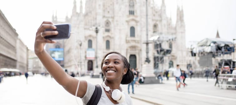 Young black woman taking selfie with smart phone in Milan