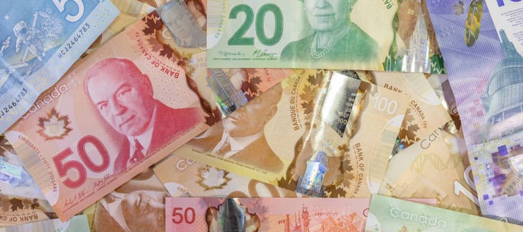 Canadian money paper bills and cash in a pile background. Learning to save money and keep a budget